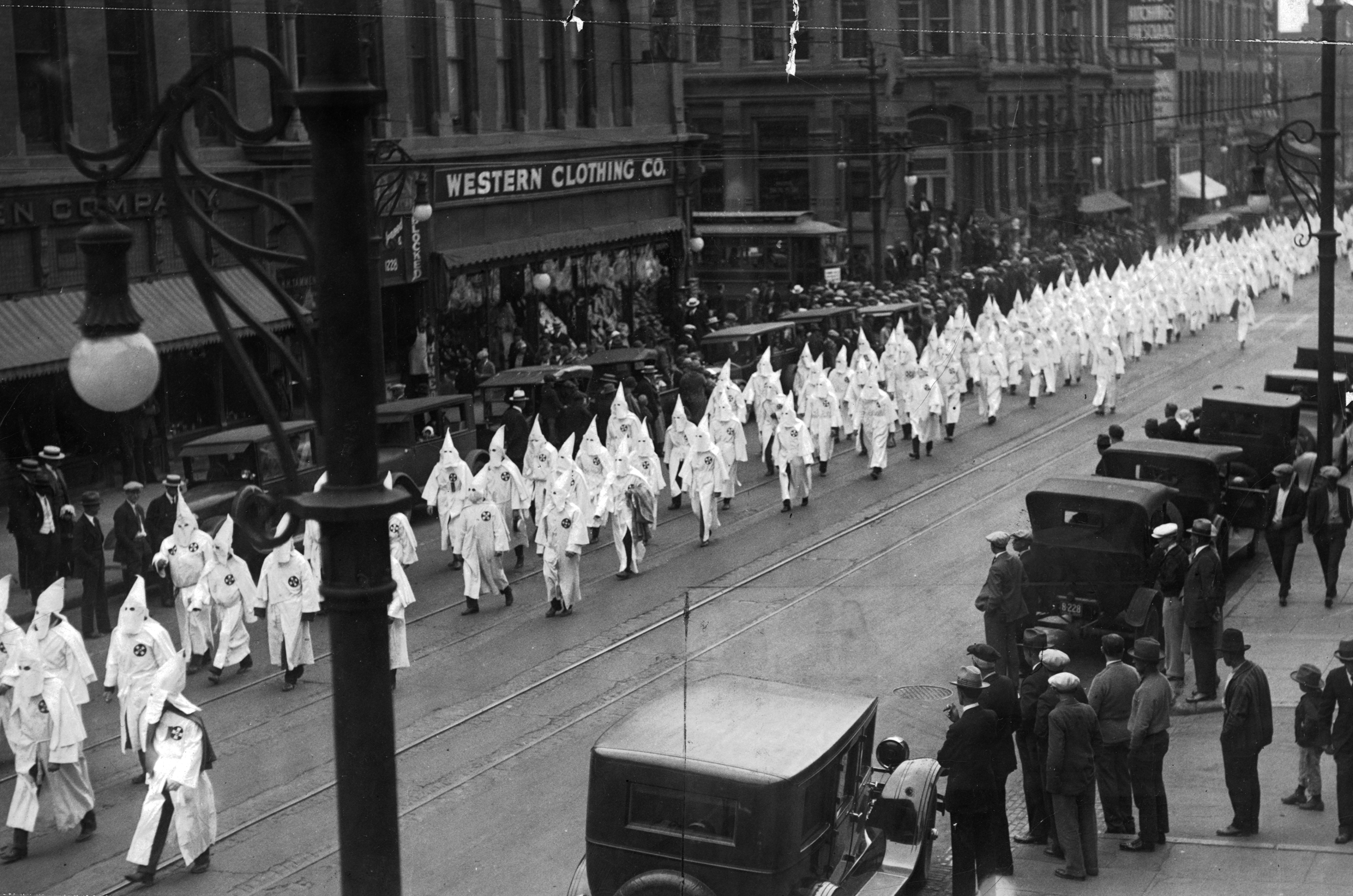 Members of the Klu Klux Klan march down 17th Street in Denver