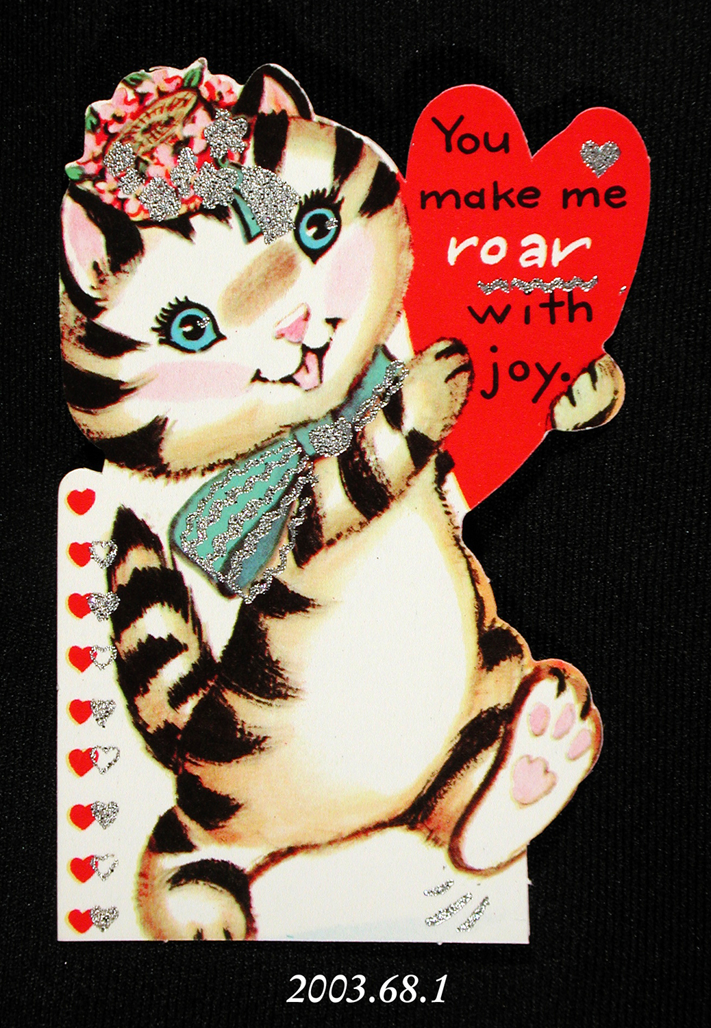 A glittery valentine card depicting a cat. It reads: "You make me roar with joy."
