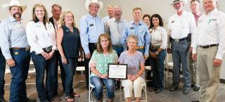 Members of the CTL Farm & Ranch family (seated) with their certificate.
