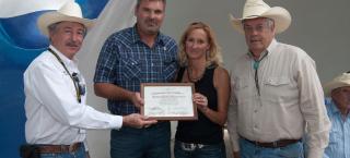 Members of the Richardson family receive the Centennial Farm award from John Salazar (left) and Ed Nichols (right)