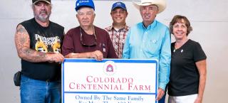 The Bailey family with their Centennial Farm sign.