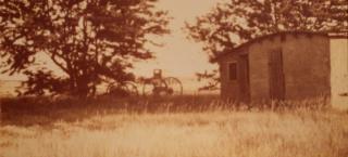 A buggy stands outside the house in an historic photograph of the Coe homestead