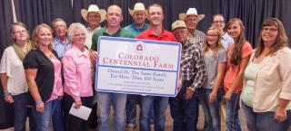 Gates family with their Centennial Farm sign.