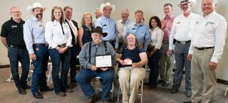 Members of the McCaw family (seated) with their Centennial Ranch certificate.