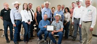 Members of Murray Farms (seated) with their Centennial Farms certificate.