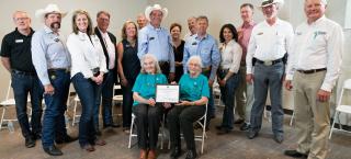 Members of the Rocking 7K Ranch family (seated) with their certificate.