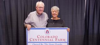 Members of Saffer Farms with their Centennial Farm sign.