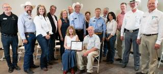 Members of Sunnyside Farms (seated) with their certificate.