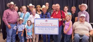 Haynes Hereford Ranch family with their Centennial Farm sign.