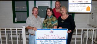 Walker Family Ranch members with their sign.