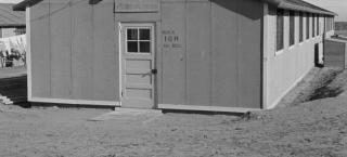 Photo from Amache internment camp in 1943 - a wooden framed, one-story building named Block 10-H