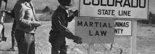 National Guard posting a sign at the Colorado border declaring martial law