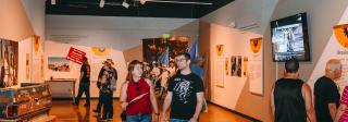 Visitors viewing Steel City: 1980-2004 at El Pueblo History Museum