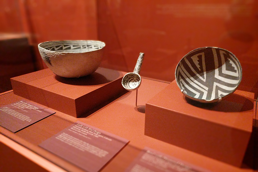2 bowls and a ladle in a display case