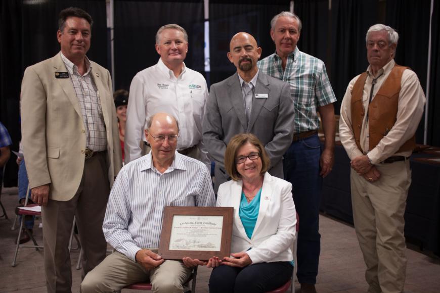 Members of the Frank E. Carnes and Evelyn C. Bricker Carnes Farm receive their Centennial farm award. 