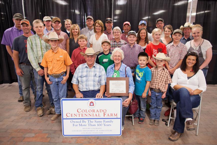 Members of the Mortensen Family Farm at the Colorado State Fair with their Centennial Farm award.