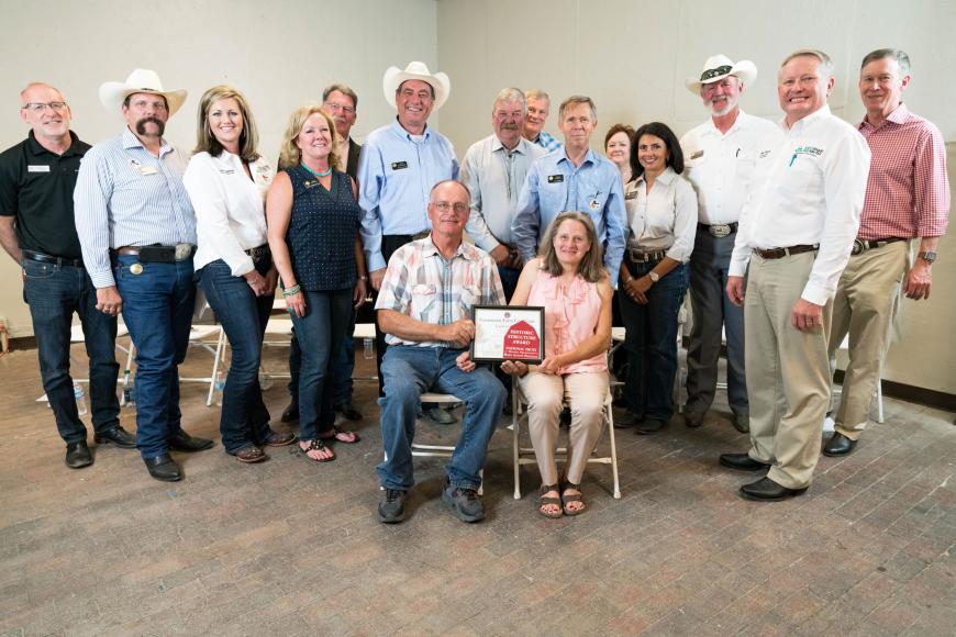 Members of the Carson Farm (seated) shown with their Centennial Farms certificate and various dignitaries, including the governor.