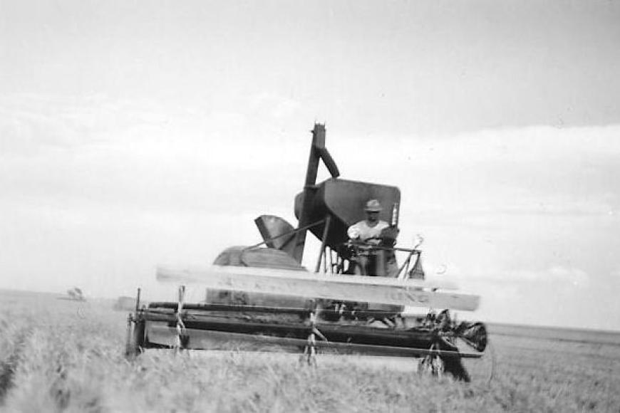 Man sitting on a harvester, facing the camera.