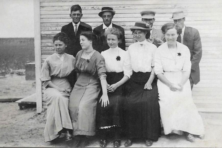 Historic photograph of young men and women dressed in their best.