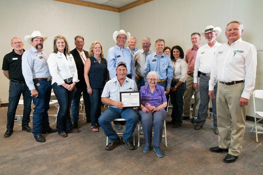 Members of the Glenn Doddridge Farm & Ranch (seated) with their certificate.