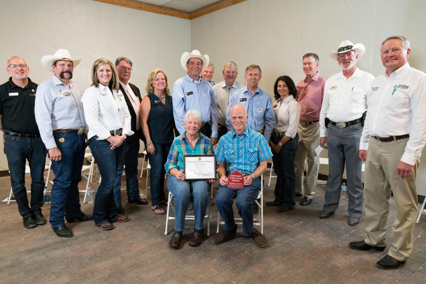 Members of the Long family (seated) with their Centennial Farms certificate.