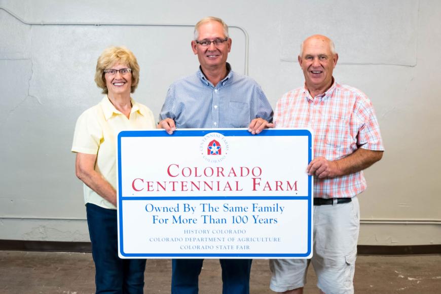 Members of the Seger family with their Centennial Farms sign.