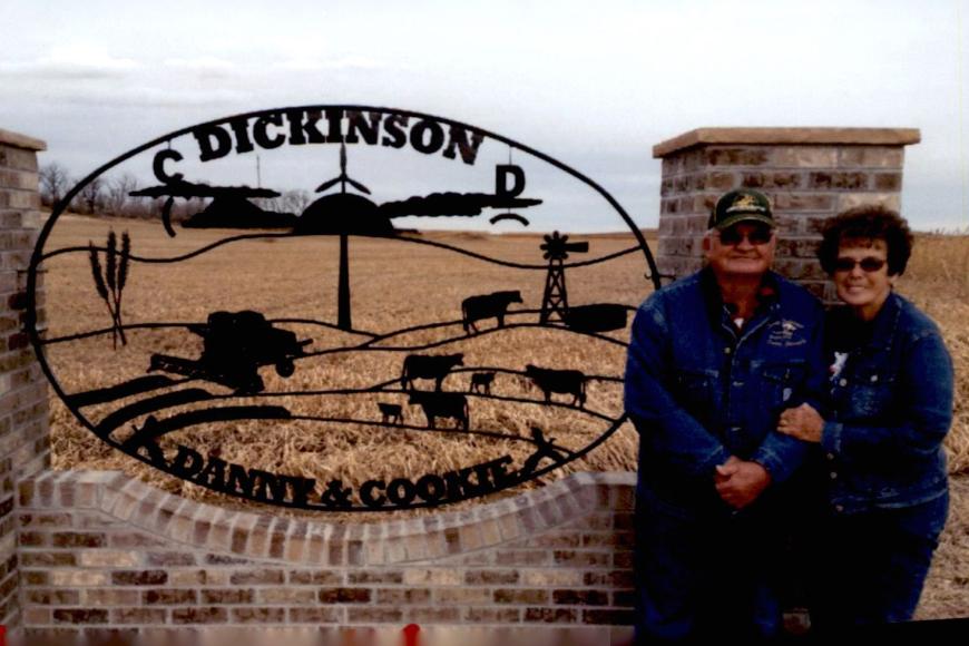Danny and Cookie Dickinson stand by their ranch sign.