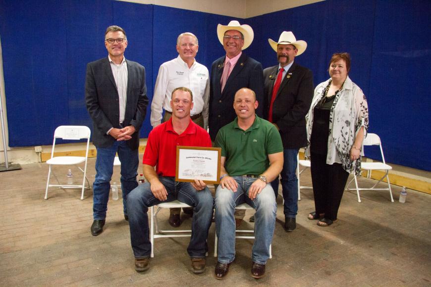 Members of the Gates family (seated) with their Centennial Farm certificate.