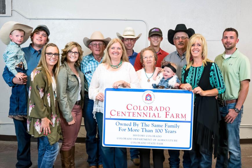 Members of the Kanode family with their Centennial Farm sign.