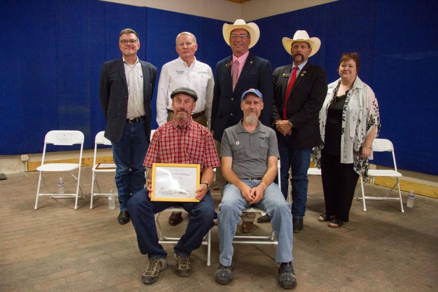 Members of the Koch family (seated) with their Centennial Farm certificate.