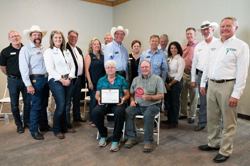 Members of the Mill Iron D Ranch family (seated) with their certificate.
