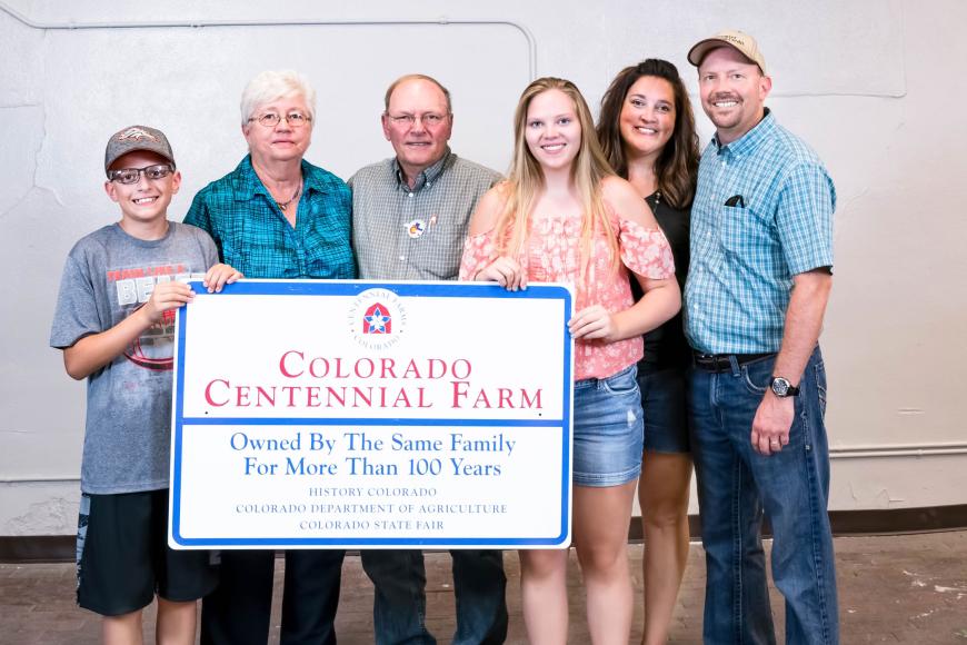 The Dollerschell family with their Centennial Farm sign.