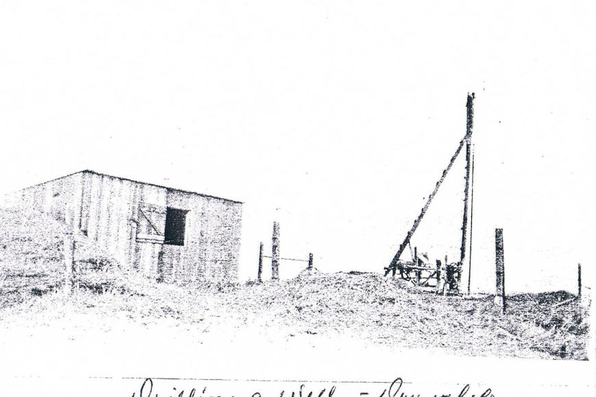 Historic image with the caption, "Drilling a well - dry hole".