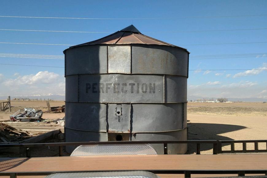 A silo with the word "Perfection" on it.