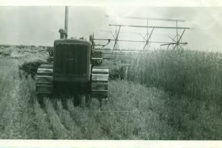 Historic photo of a tractor tilling a field.