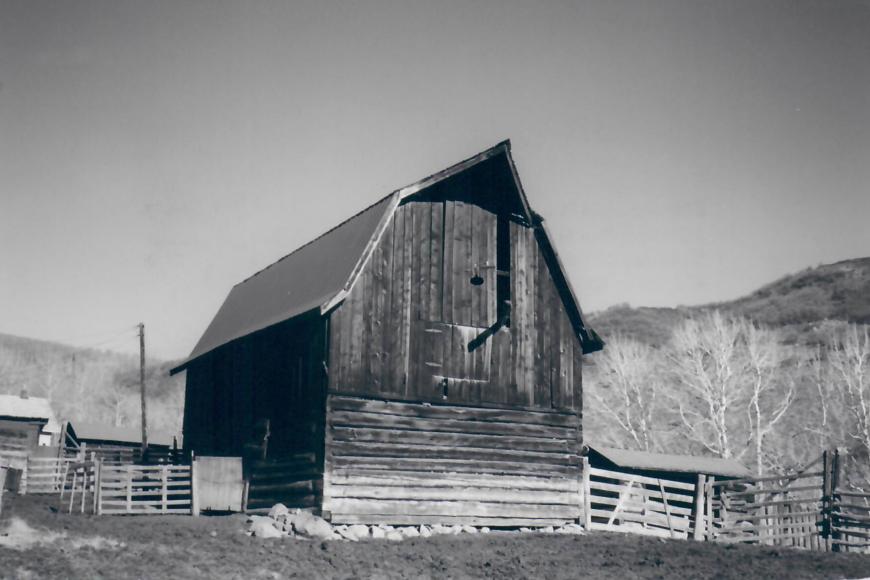 A two-story barn with a gambrel roof.