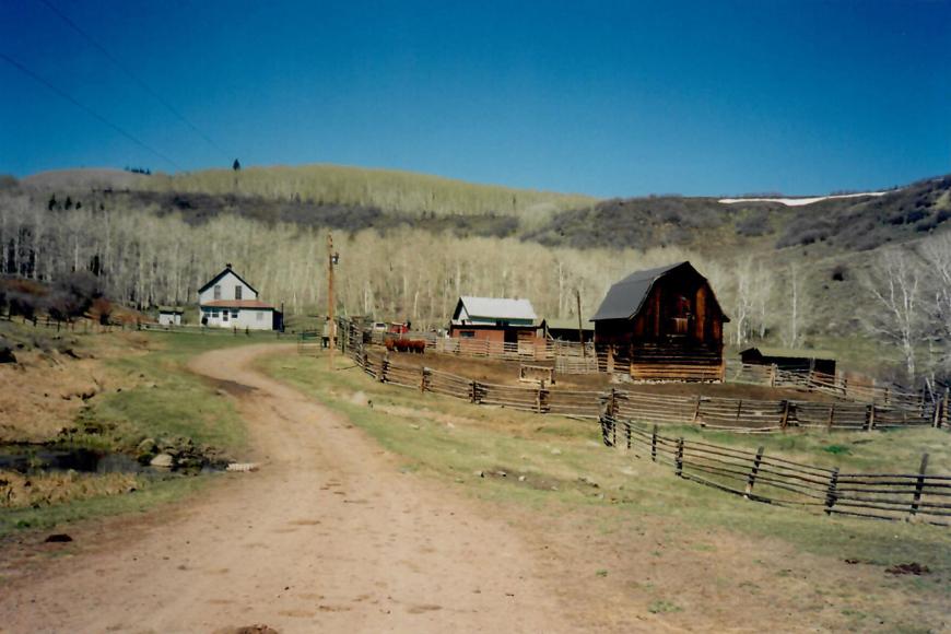 A view of the ranch showing the house, the barn and other buildings.