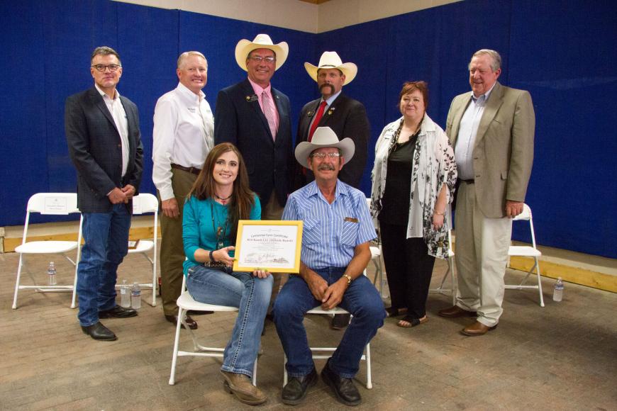 Smith family of RLS Ranch (seated) with their Centennial Farm certificate.