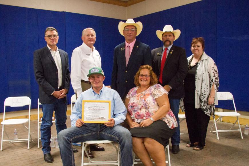 Members of the Wacker family (seated) with their Centennial Farm certificate.