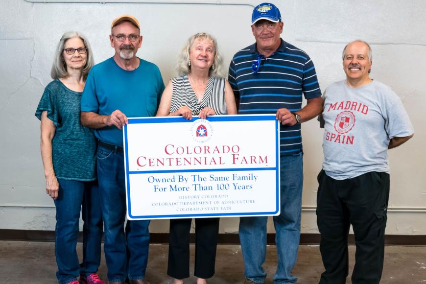 Fulbright family with their Centennial farm sign.