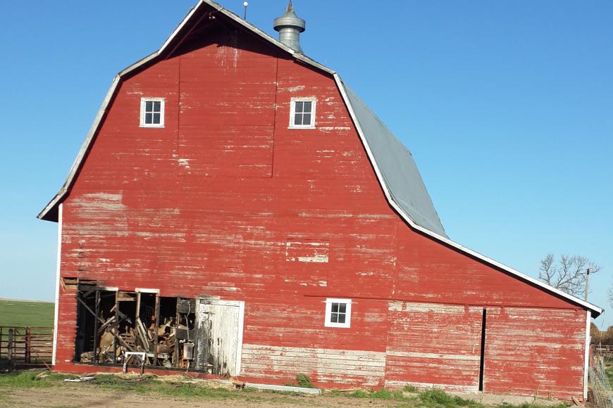 A red barn with a gambrel roof, built in 1916.