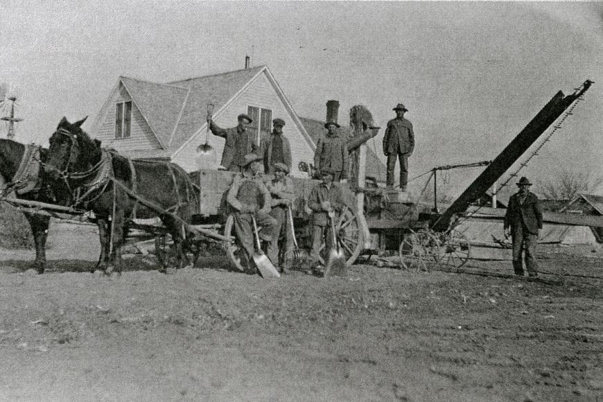 Historic image of a horse drawn wagon and people at the Deterding Farm.