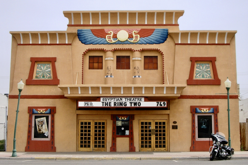 The facade of the Egyptian Theater in Delta. The building is newly restored to its original Egyptian Revival style, with Ancient Egyptian iconography covering the walls. The second story windows are stained glass, and the building is shaped like an Egyptian temple.