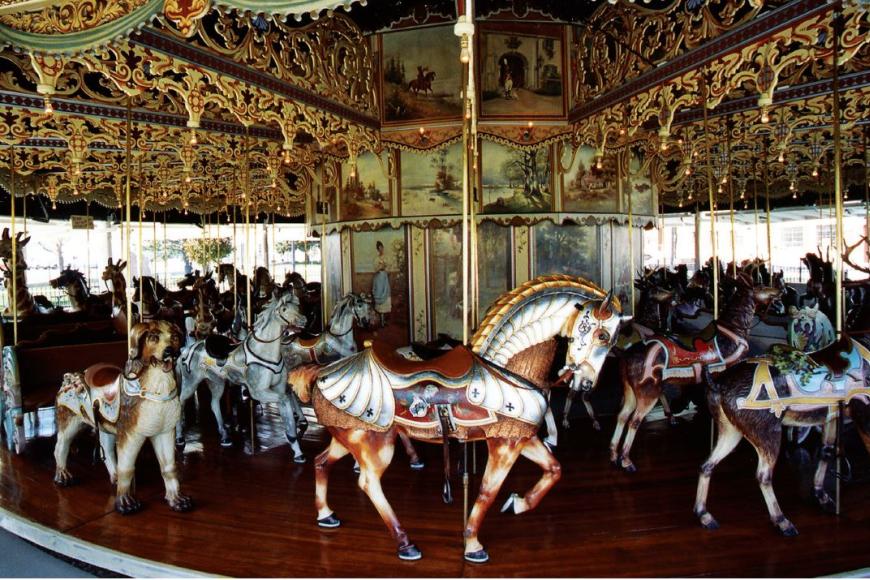 The Kit Carson Carousel up close, with the menagerie of animals visible, including horses, dogs, reindeer, and giraffes.