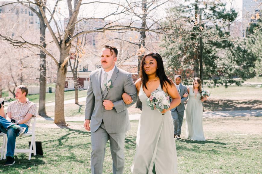 Bridesmaid and groomsman approach the altar at an outdoor wedding at Grant-Humphreys Mansion