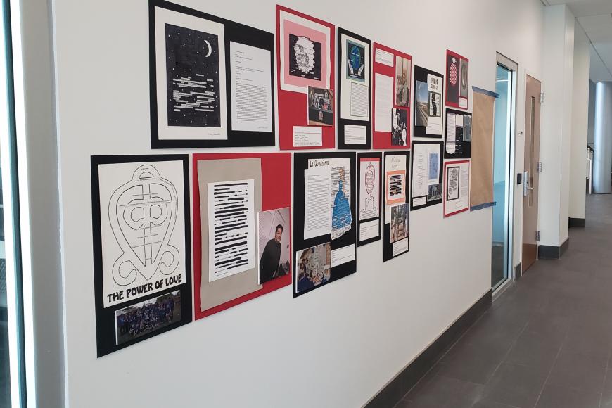 Bruce Randolph Projects on Display at CSU Spur. The projects are on display on a wall within a unvierity building. They include photographs, writing excerpts, hand-made charts and artistic designs, etc.
