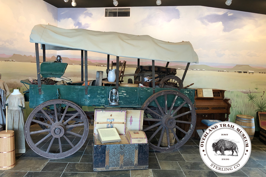 A green covered wagon on display in the Overland Trail Museum. 