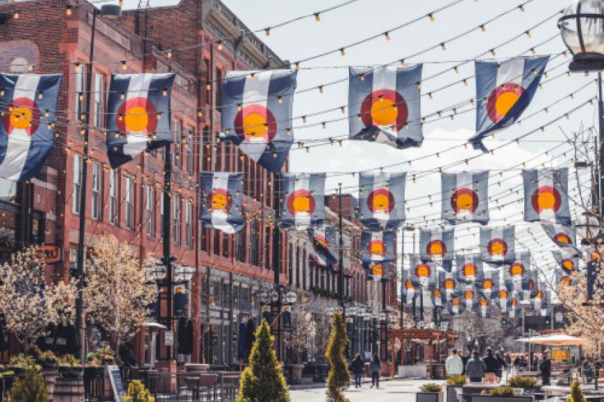 Larimer square filled with Colorado flags hanging above the street.