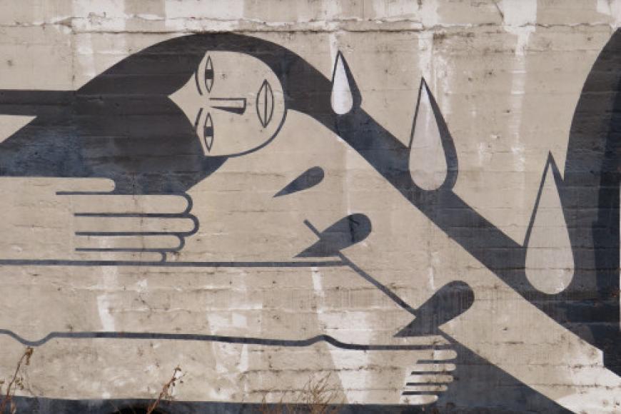 Mural on a cement wall in Cherry Creek, CO, it shows an abstract black and white woman with thorns emerging from her arms.