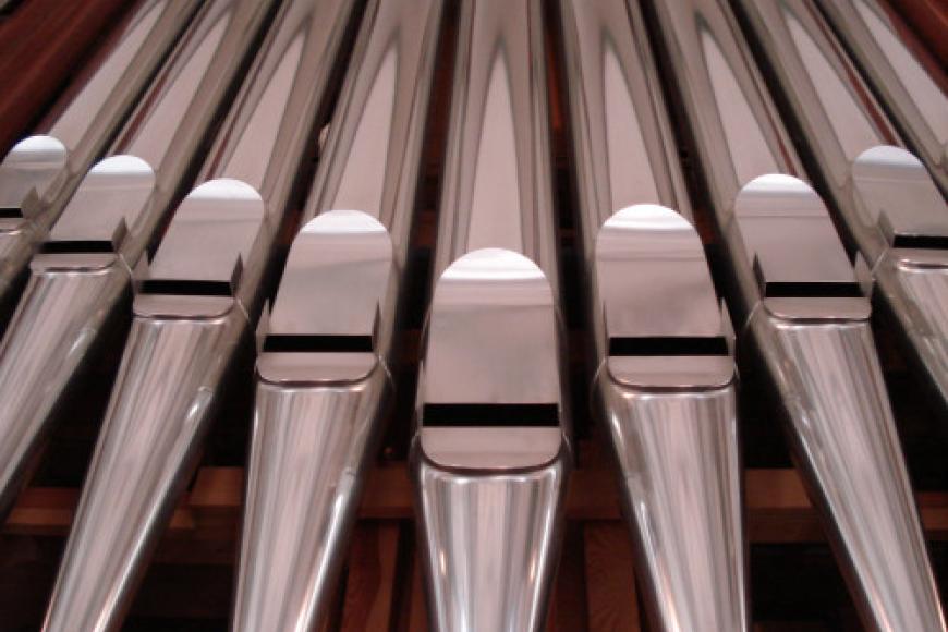 Closeup of silver organ pipes.